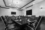 Spacious on-site boardroom featuring ample seating, large table, and TV's for presentation.