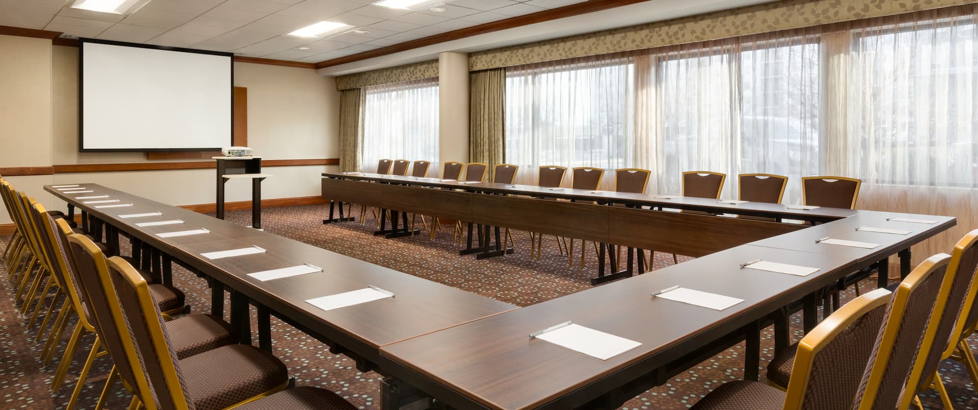 Meeting Room with U-Shaped Conference Table and Projector Screen