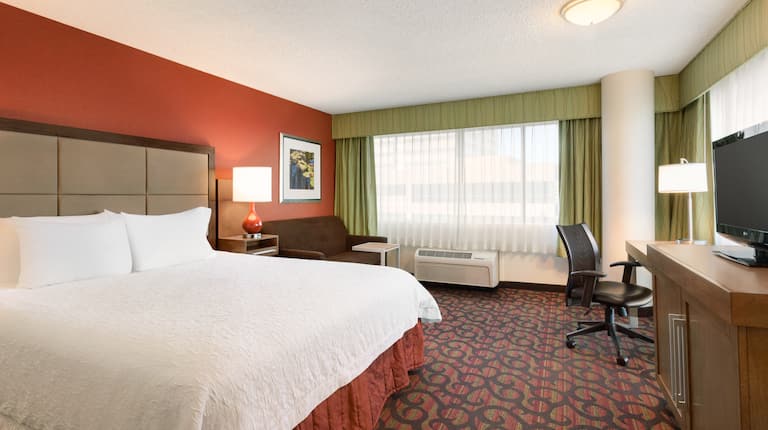 Guestroom with King Bed, Couch, Work Desk and Television