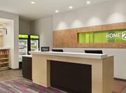 Welcoming front desk in lobby with Hilton Honors sign and convenient fully stocked market.