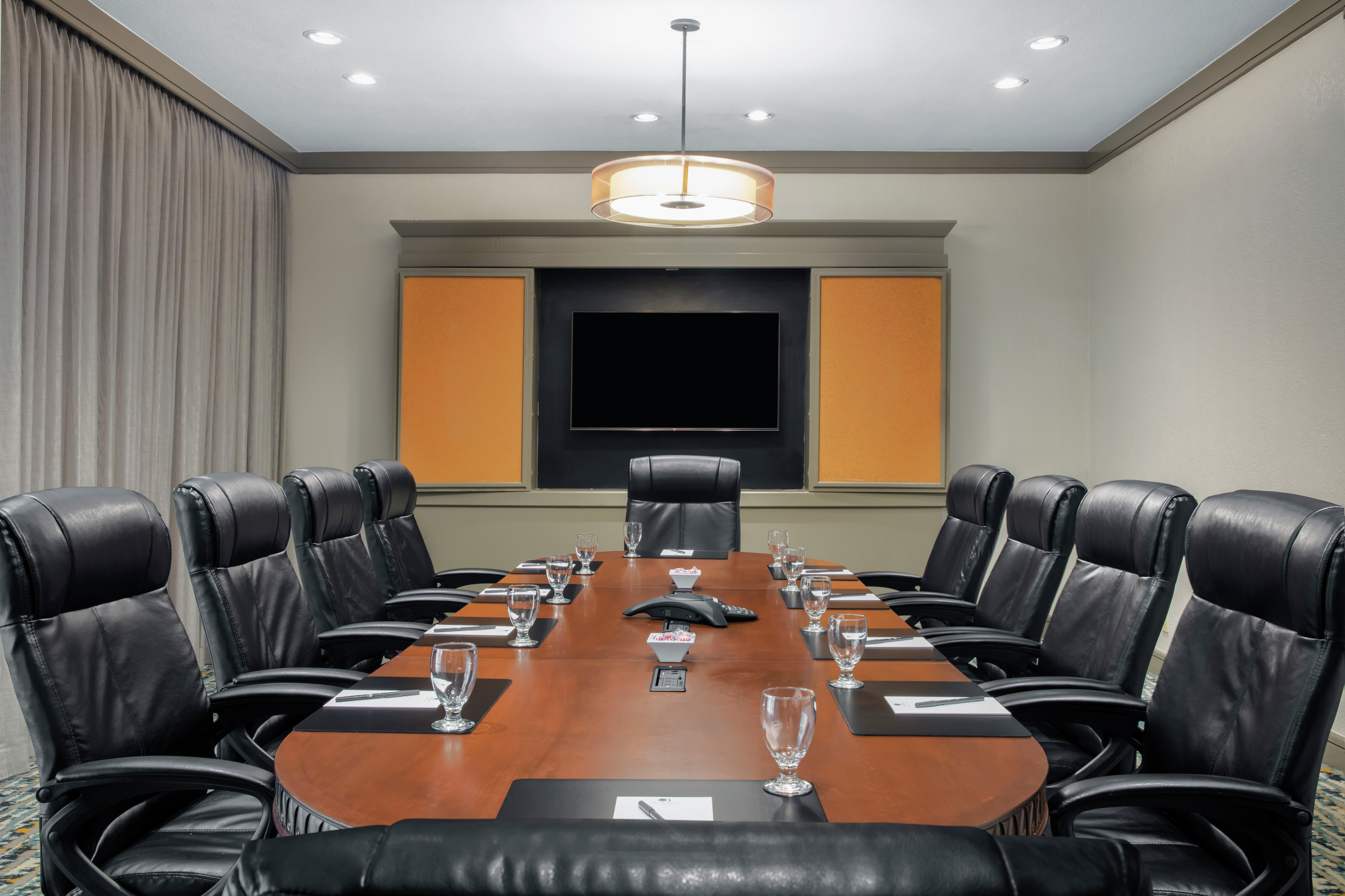 a boardroom table and chairs in a conference room