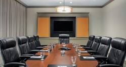 a boardroom table and chairs in a conference room