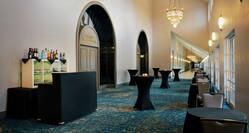an event space hallway with tables and a bar