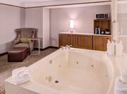 Executive Suite Living Room With Whirlpool Tub, Soft Chair Seating. and Microwave