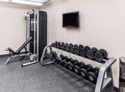 Fitness Center with TV, Weight Bench, and Free Weights