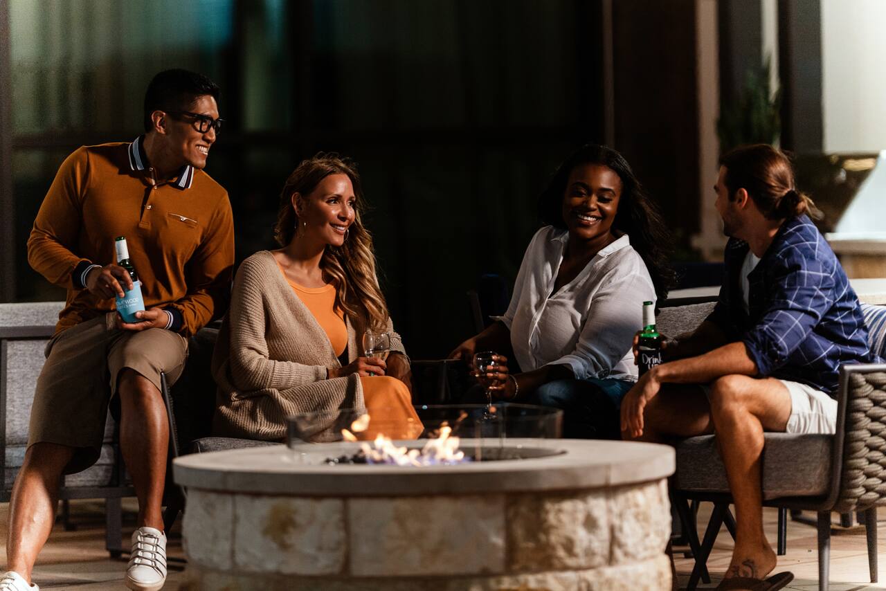 group of people sitting around a firepit