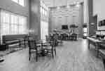 DFW hotel breakfast seating area with
  high ceilings and plenty of natural lighting