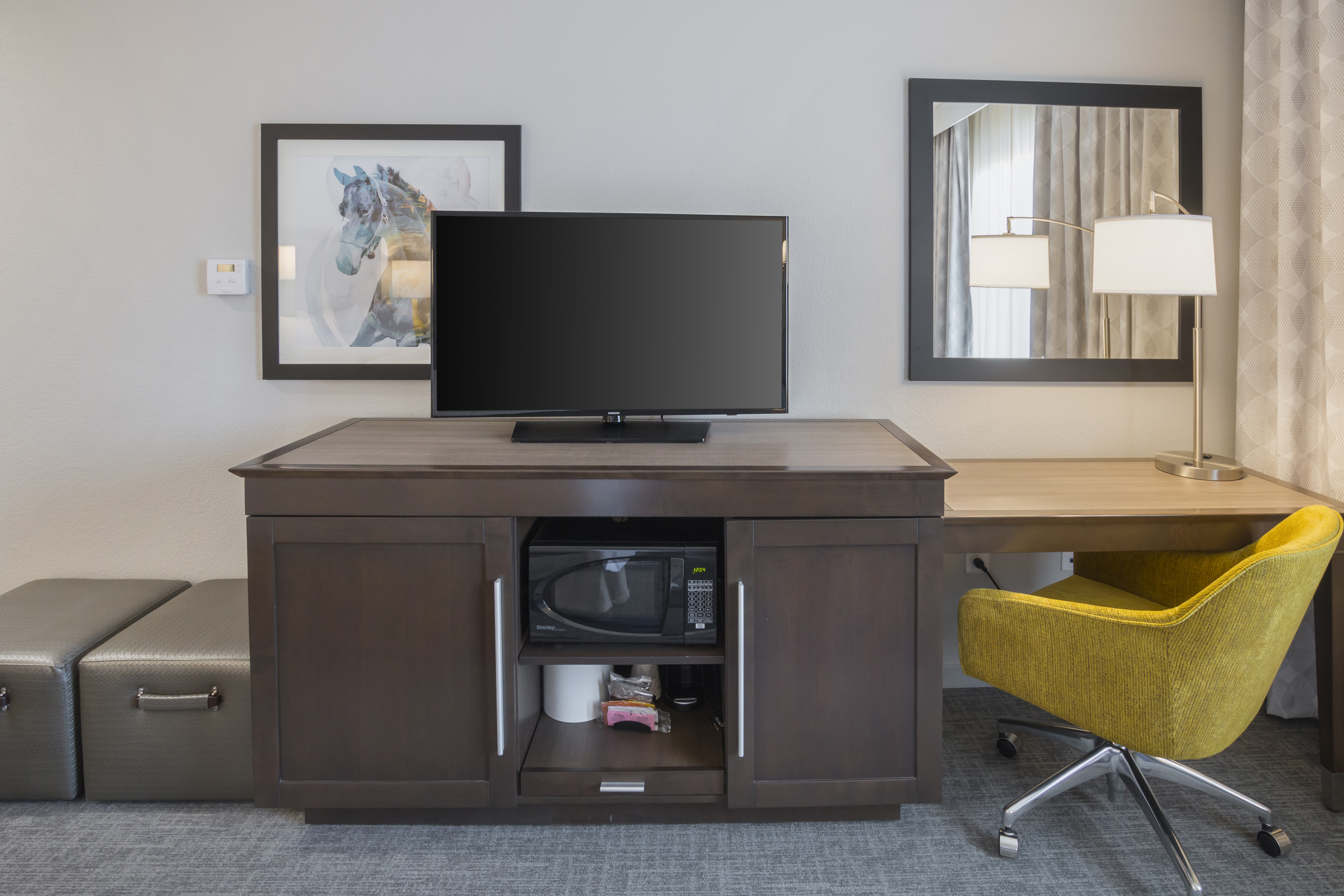 Hotel guest room entertainment center
  with flat screen TV and desk with desk chair 