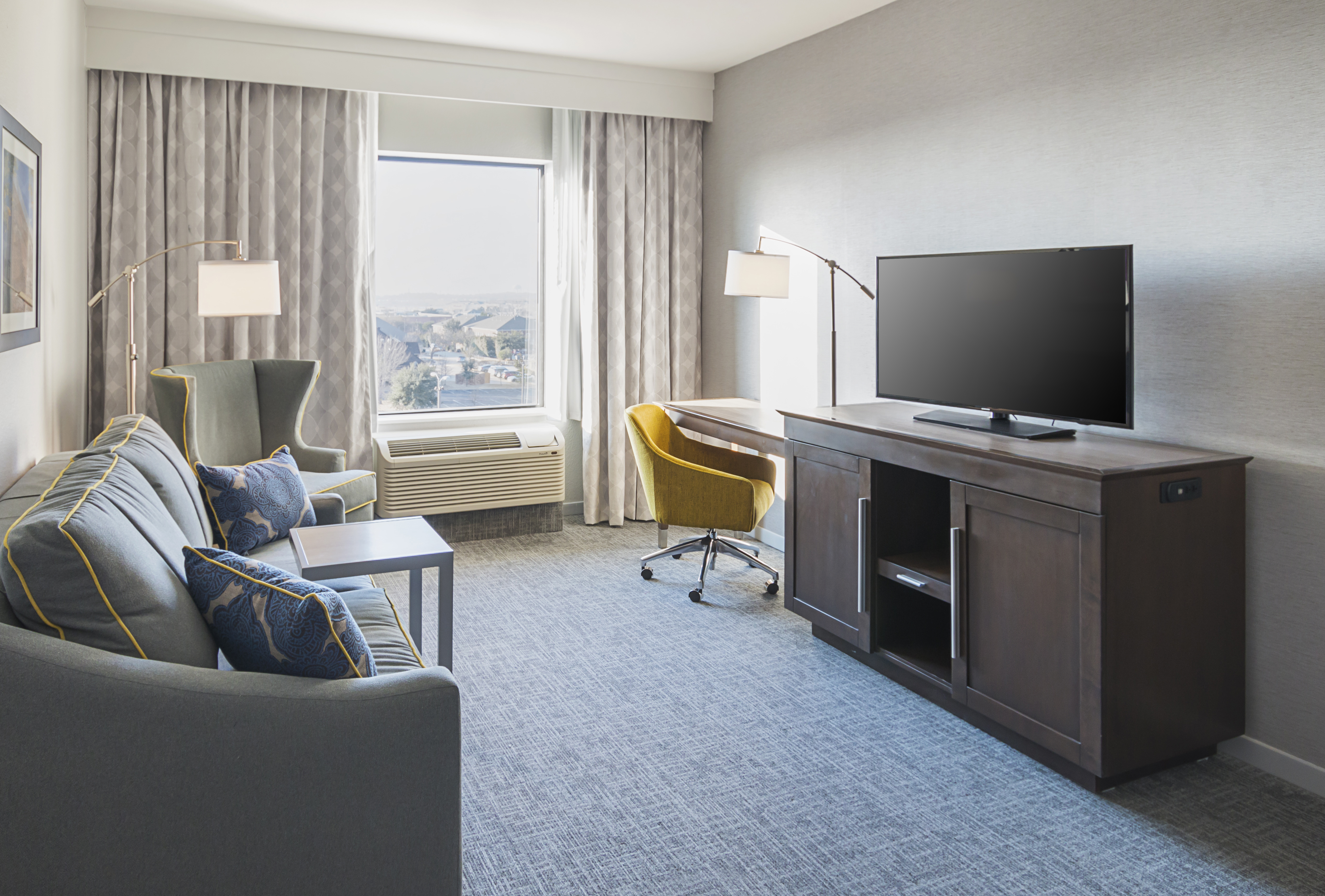 Dallas Forth Worth airport hotel suite
  with sofabed and entertainment center 