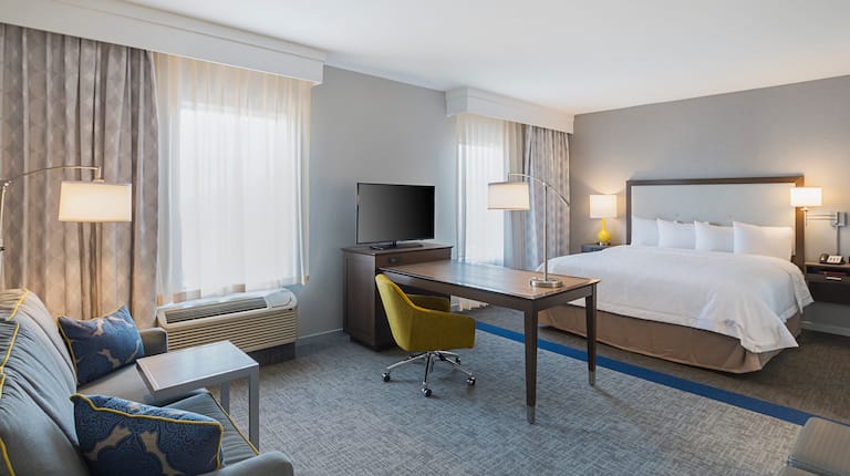 Dallas airport hotel king studio suite
sofabed, desk and king size bed with four pillows and bedding