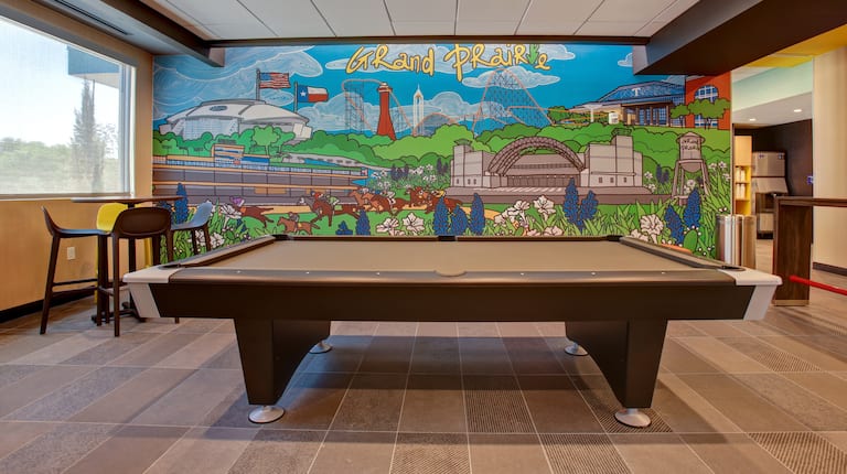 lobby lounge area with pool table and mural