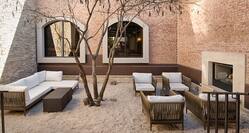 Outdoor Patio Seating Area with Sofa, Footrest, Armchairs and Tree