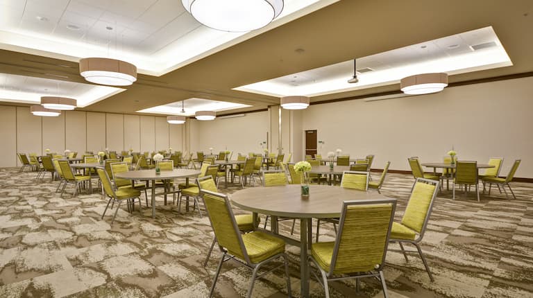 Spacious Ballroom with Roundtables and Chairs