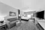 Guest Room with a Comfortable Bed, Lounge Area, and Work Desk