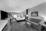Guest Room with Two Comfortable Beds, Lounge Area, and Work Desk