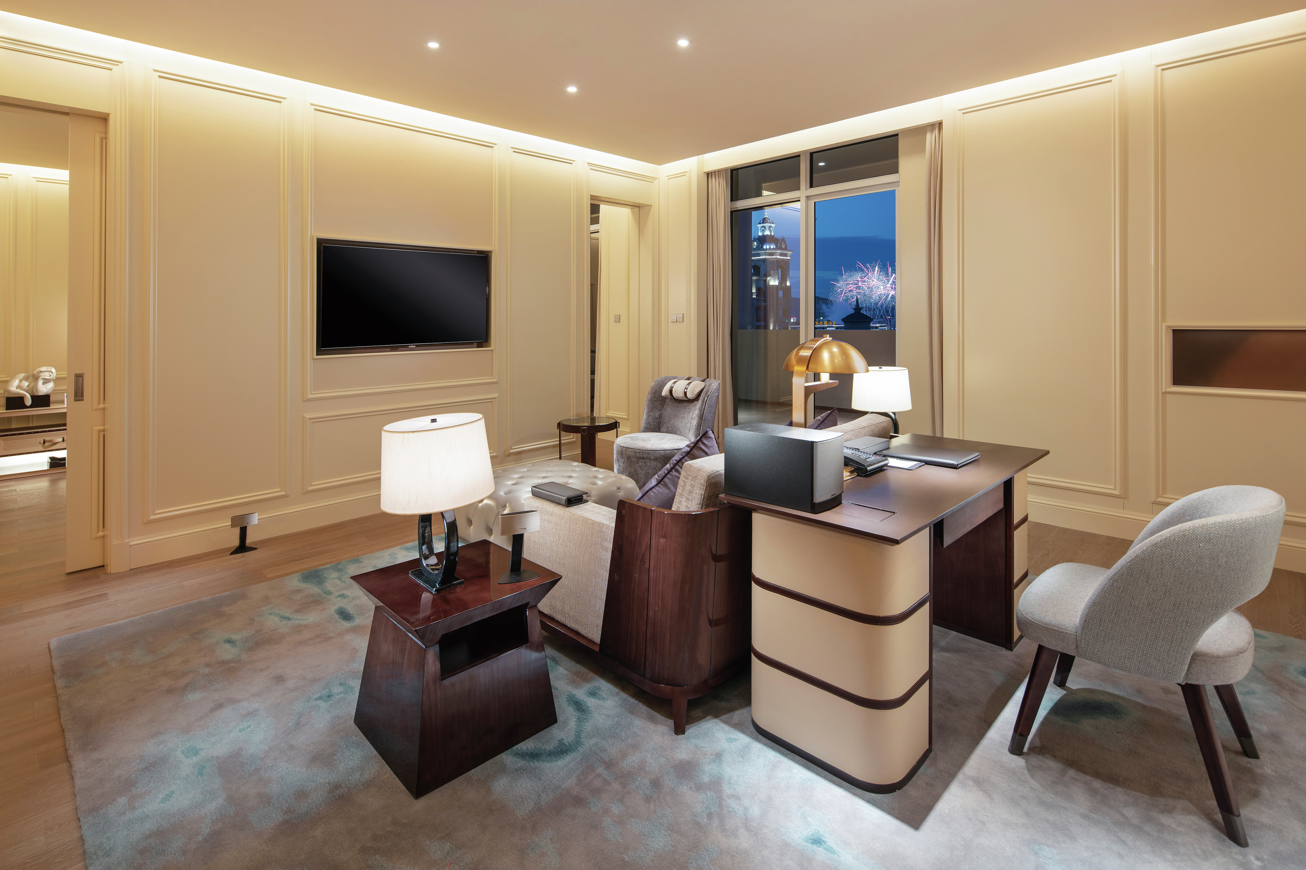 Work Desk, Chair, Lounge Area, and TV in Deluxe Suite Working Area