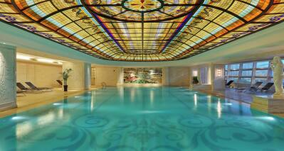 Indoor pool with ornate ceiling