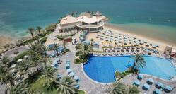 Panoramic View of Hotel with Pool and Beach with Seating Area