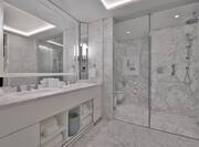Bathroom with vanity, two sinks and shower