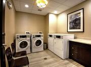 Guest Laundry Room with Coin Operated Machines and Folding Table