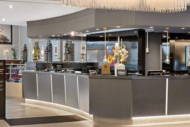 Lobby area with front desk and hotel signage