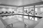 Pool with chairs around it and a pool lift