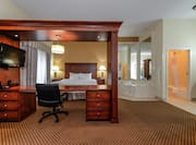 King Suite with Bed, Work Desk, Room Technology, Whirlpool Tub, and Bathroom with Shower and Bathtub