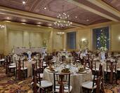 Ballroom with chandeliers set up for a wedding party