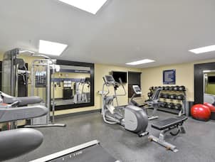 Fitness Center with Dumbbell Rack, Cycle Machine, Cross-Trainer, Weight Bench, Weight Machine and Wall Mounted HDTV