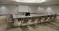 Meeting room with tables and chairs in u-shape layout