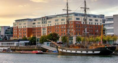 Hotel Exterior with View of Boats on River Liffey