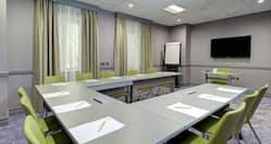 Bay Room Meeting Room with U-Shaped Table, Chairs, and Room Technology