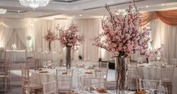 Wedding set up with pink floral center pieces. 