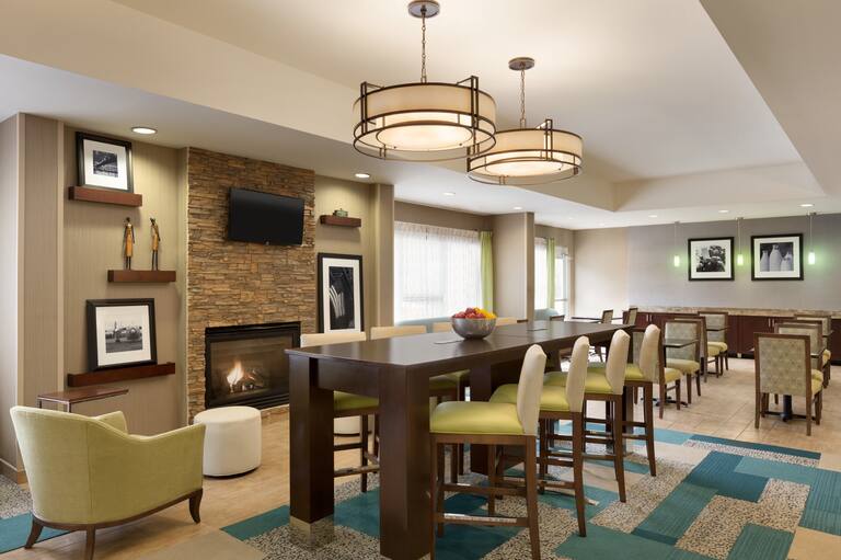 Lobby Seating Area with Chairs, Tables, Wall Mounted HDTV and Fireplace
