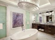Suite Bathroom with Spacious Tub and Elegant Lighting
