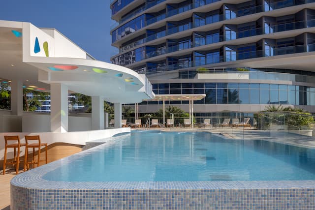 Outdoor pool with chairs and loungers