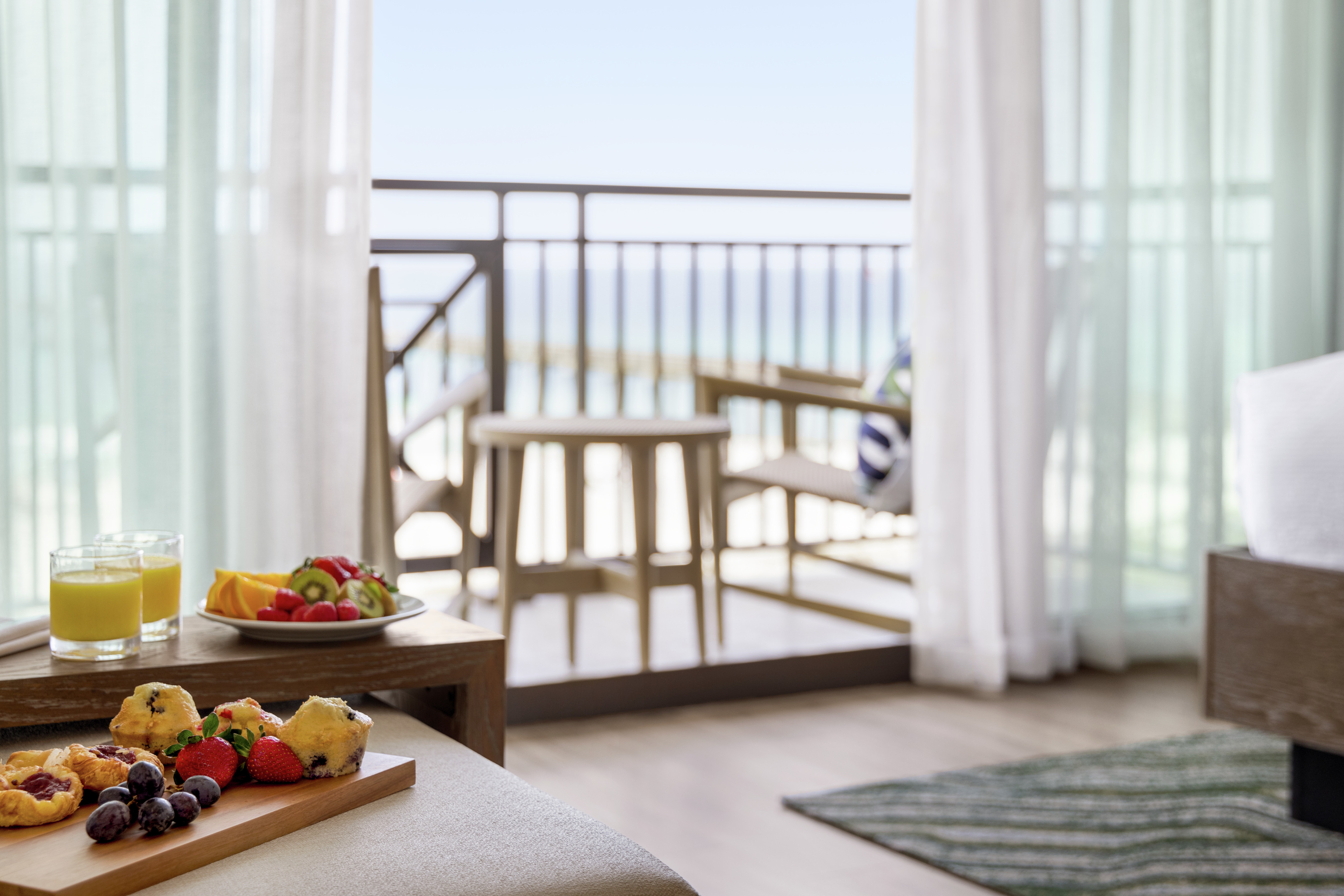 Inviting morning breakfast set up leading out to balcony seating and ocean views