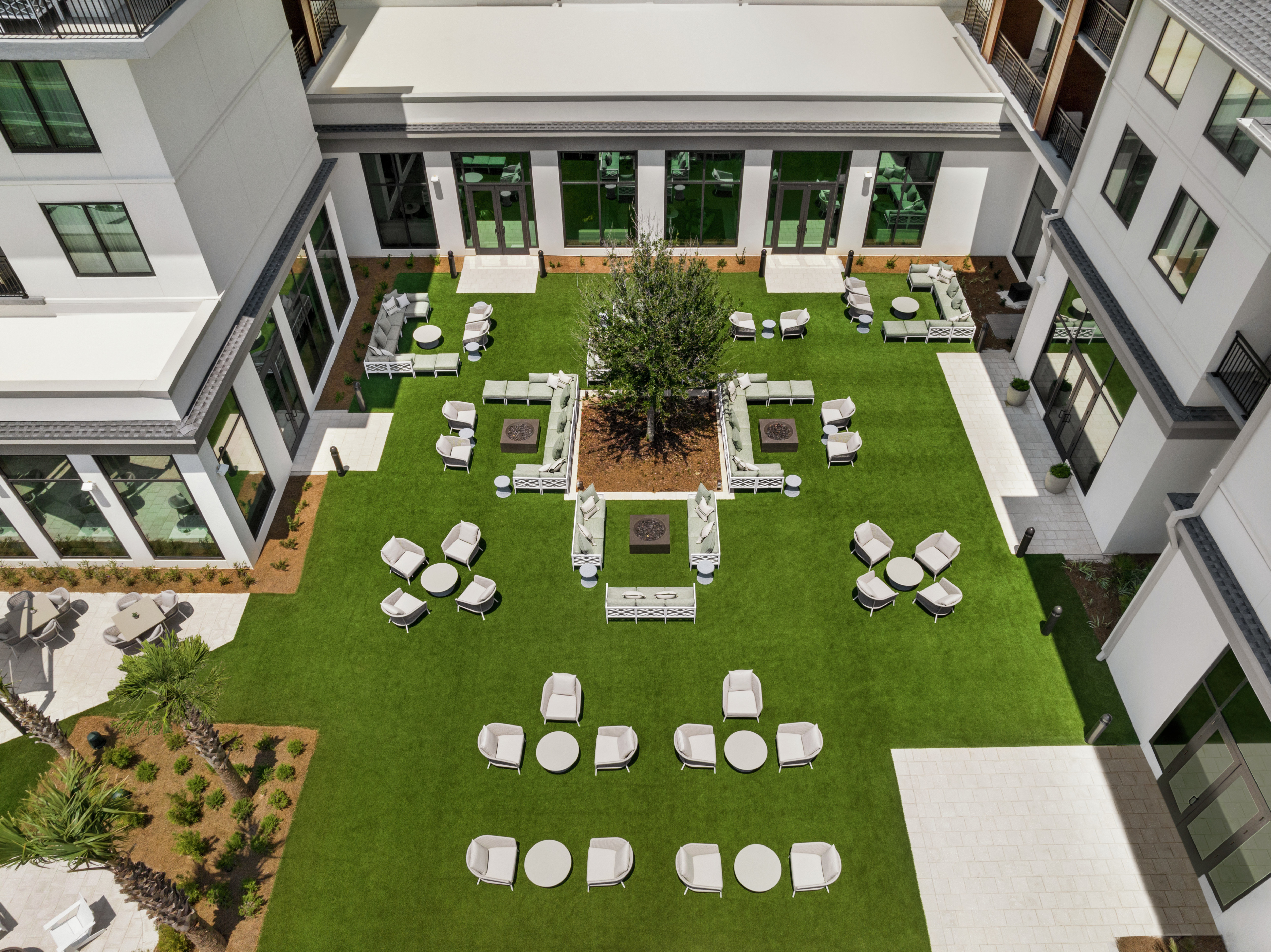 Overhead view of beautiful outdoor courtyard with gorgeous resort landscaping and plentiful seating areas