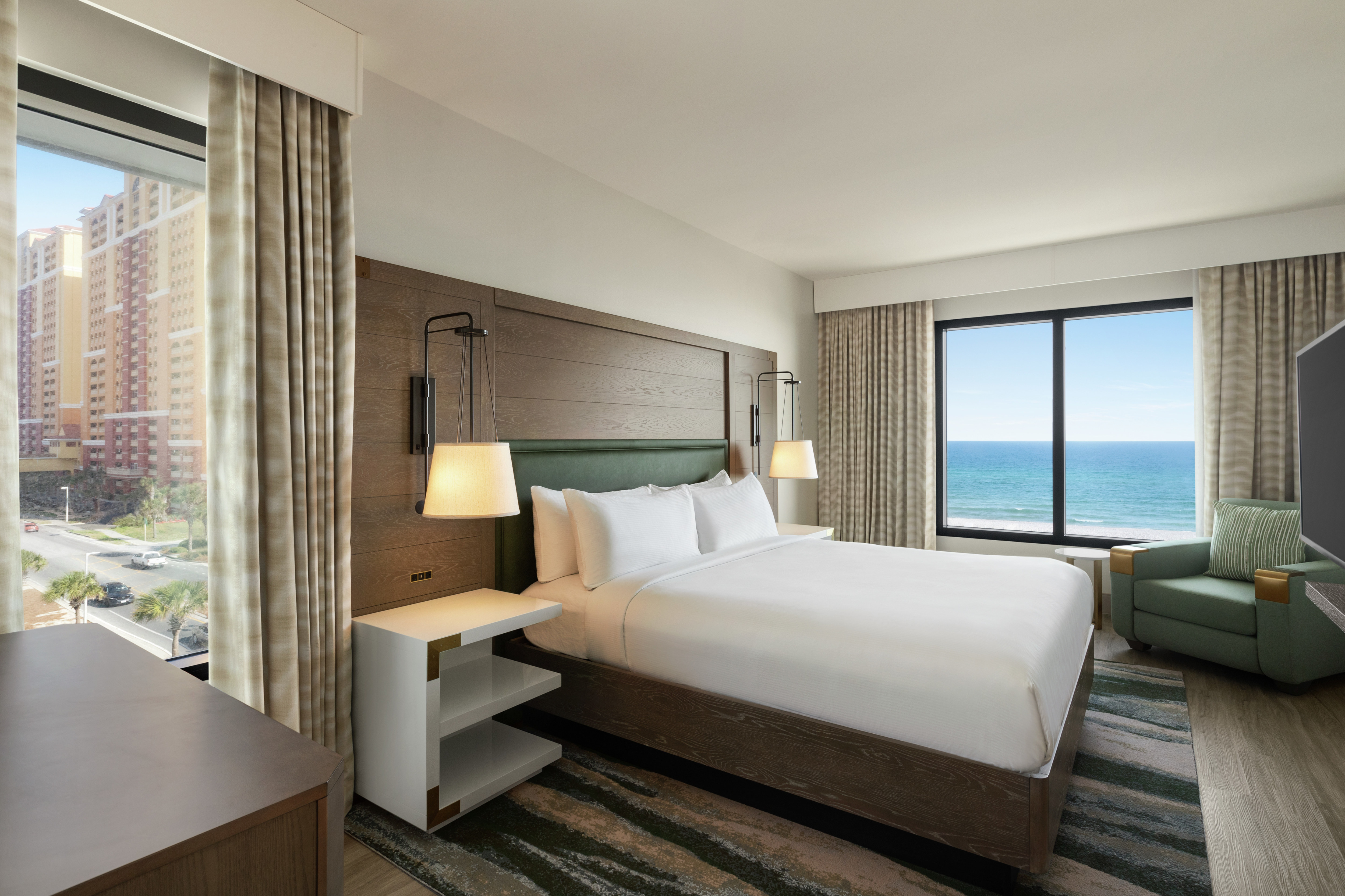 Spacious guest room featuring plush king bed and resort styling with stunning ocean and local views