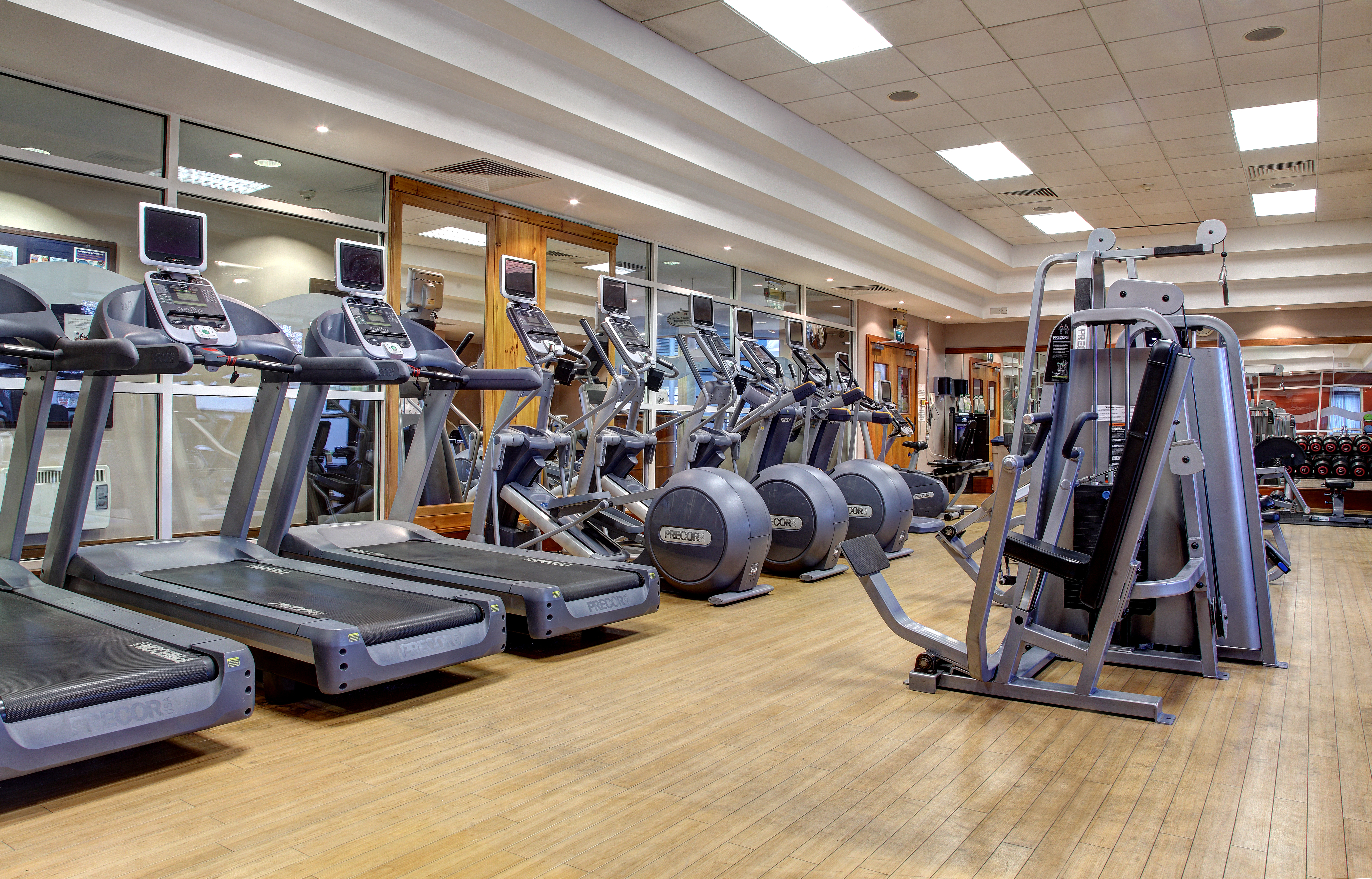 Fitness Center With Cardio Equipment, Weight Machines, Free Weights and Mirrored Walls