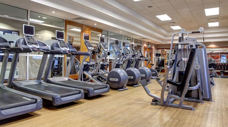 Fitness Center With Cardio Equipment, Weight Machines, Free Weights and Mirrored Walls