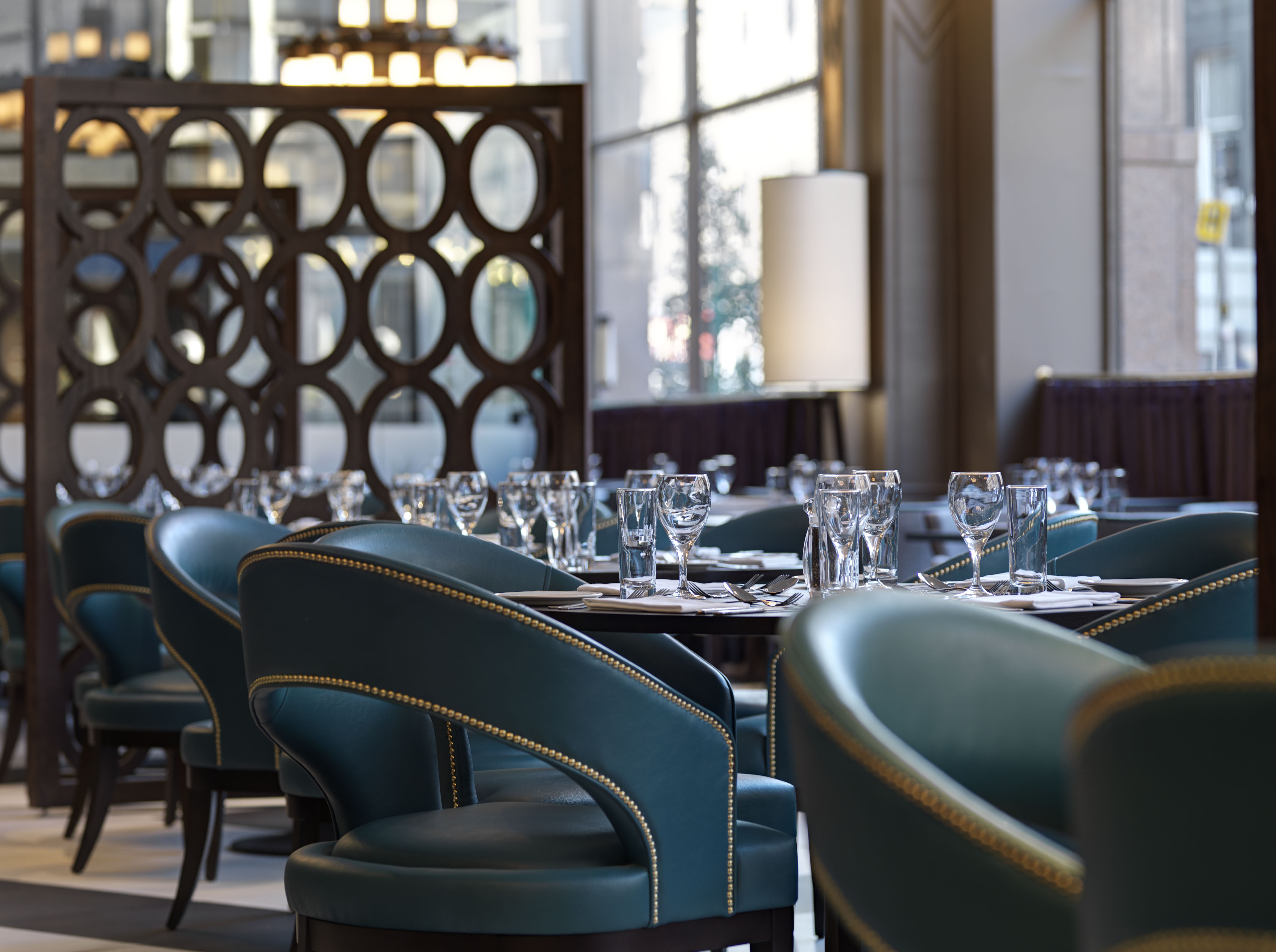 Green Chairs and Dining Tables With Place Settings and Glasses in Bread Street Brasserie Restaurant