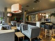 Soft Seating and Tables in Lounge Area With Counter Seating at Fully Stocked Monboddo Bar