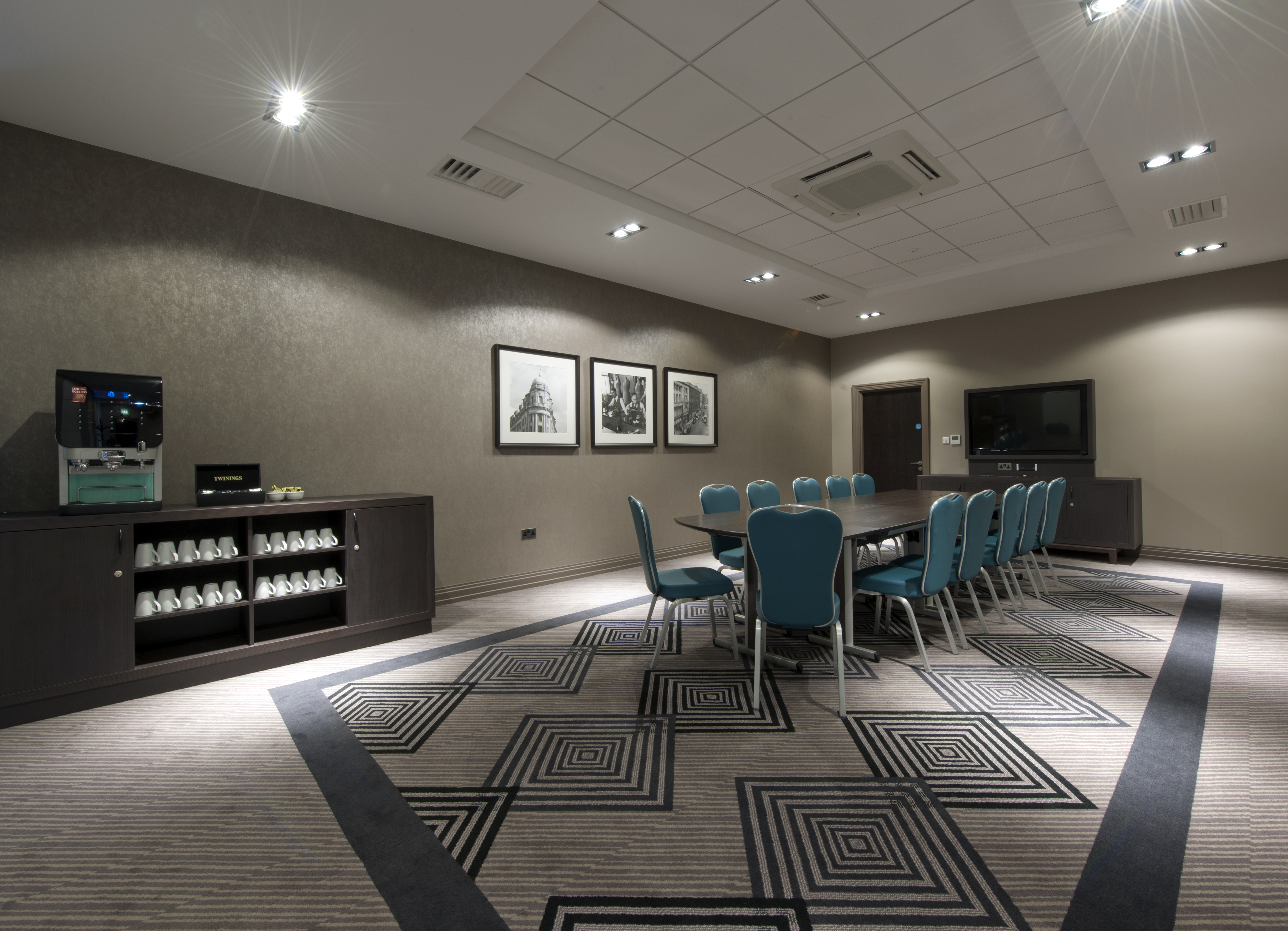 Beverage Station, Wall Art, TV, and Seating For 12 Around Boardroom Table