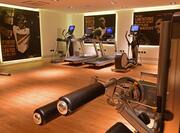 Fitness Center With Inspirational Wall Murals, Cardio Equipment, and Weight Machine