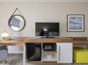 Microwave, Mini-Fridge, Flat Screen TV, and Work Desk with Illuminated Desk Lamp and Chair in Accessible Guest Room