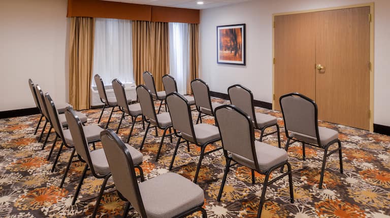 Rear View of Three Rows of Chairs Set Up in Meeting Room