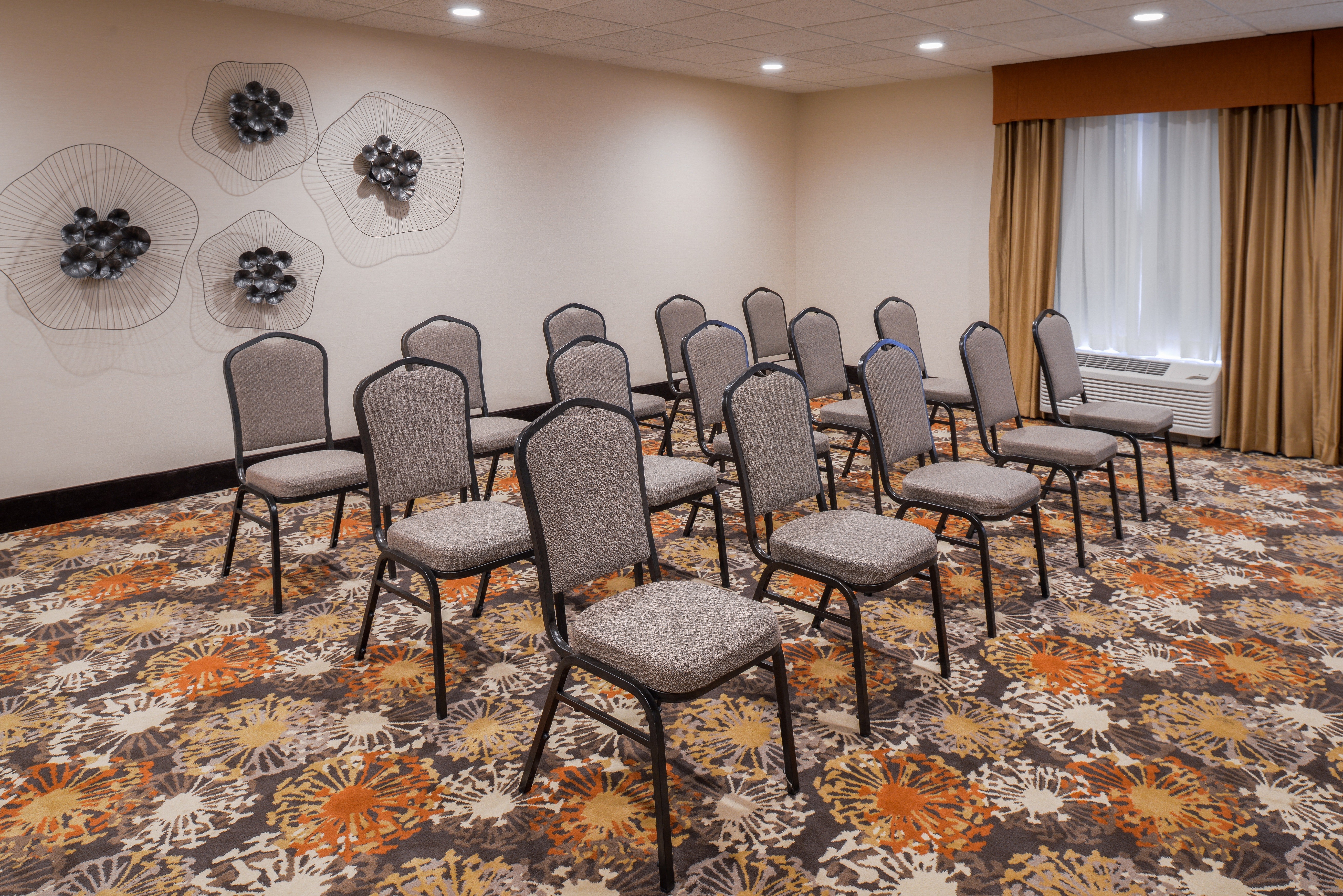 Meeting Room with Fifteen Chairs Set Up in Three Rows, a Diagonal View