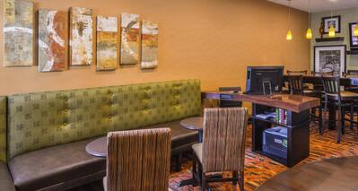 Booth with Two Chairs and Wall Art in Breakfast Dining Area