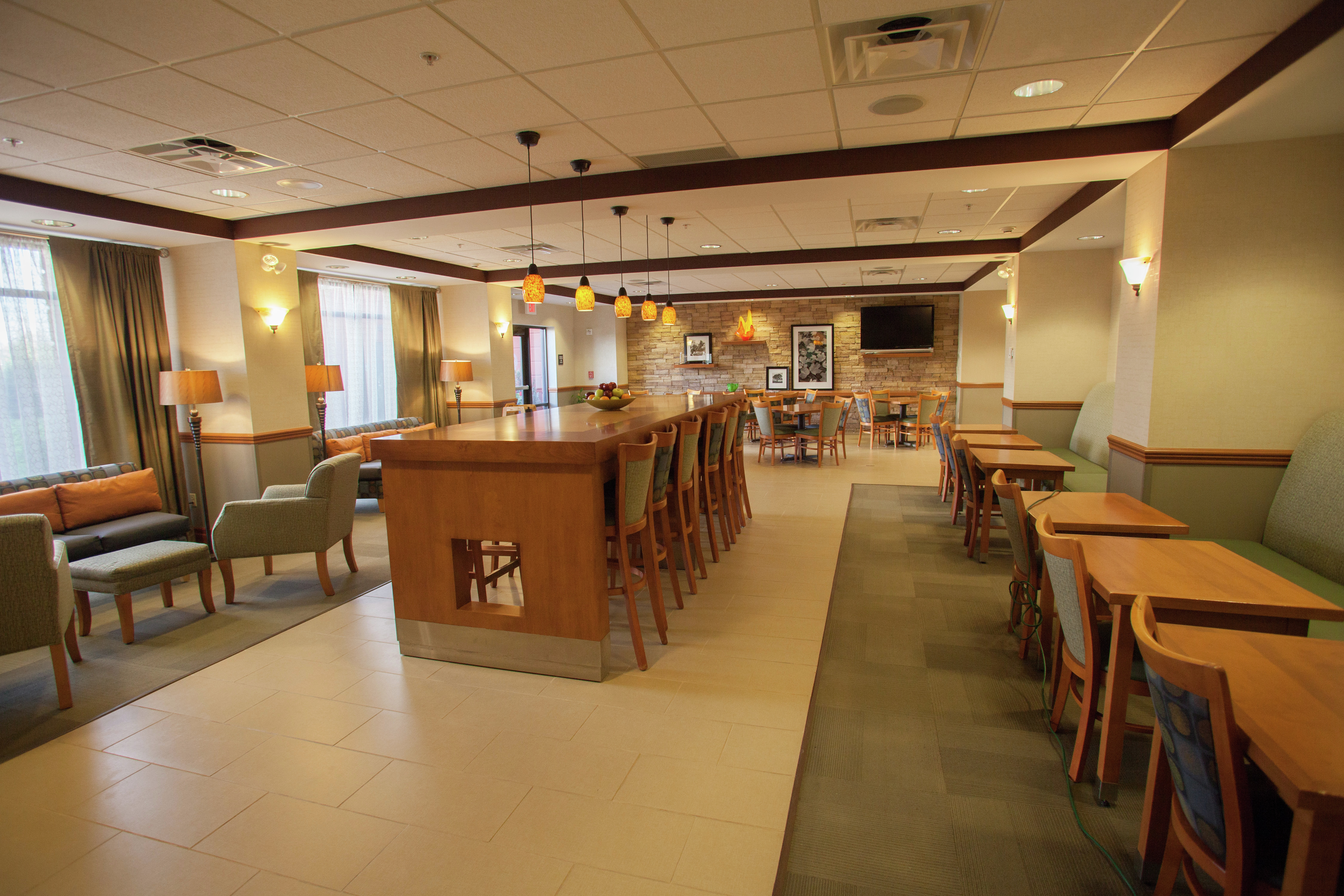 Dining Tables, Community Table, and Chairs in Breakfast Dining Area in Lobby